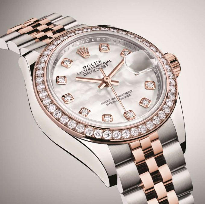 The white dial fake watch is decorated with diamonds.